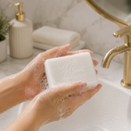 Person holding a bar of soap in the bathroom